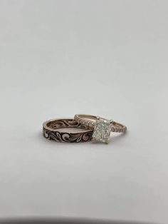 two wedding rings sitting on top of each other