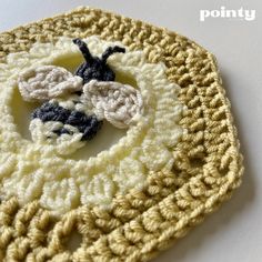 a crocheted doily with two small black and white bugs on it's center