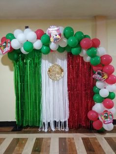 an arch made out of balloons and streamers with the flag of italy on it