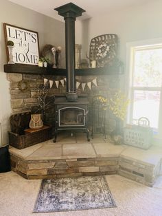 a living room with a fire place and rugs on the floor in front of it