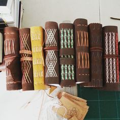 several different types of leather wrapped in brown and white thread, next to each other