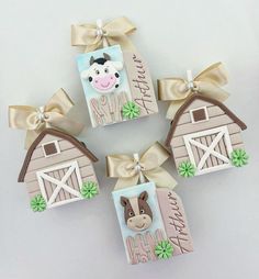 decorated cookies are arranged in the shape of farm animals and barnyards with bows