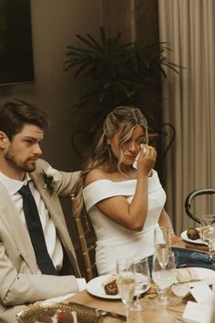 a man and woman sitting at a dinner table