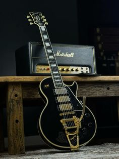 an electric guitar sitting on top of a wooden table