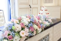 a table topped with flowers next to a cake