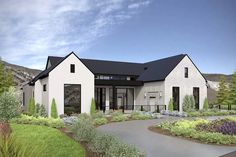 a white house with black roof surrounded by greenery