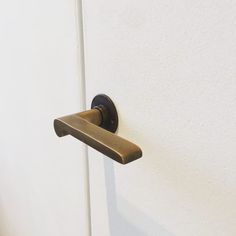 a door handle on the side of a white wall