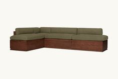 a large sectional couch sitting on top of a wooden table