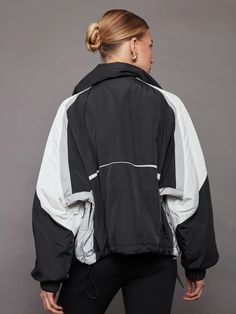 Esme Anorak - Black/ Soft White/ Reflective – Carbon38 Sporty Outerwear For Ski Season, Functional Nylon Windbreaker For Ski Season, Sporty Windproof Windbreaker For Ski Season, Sporty Nylon Windbreaker For Skiing, Sporty Nylon Windbreaker For Ski Season, Ski Windbreaker With Detachable Hood, Spring Showers, Ski Club, Carbon 38