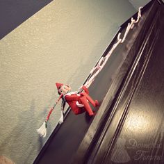 the elf is hanging on the door handle