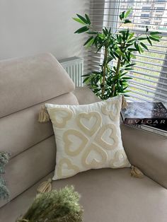 a chair with a pillow on it next to a potted plant