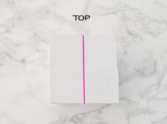 a piece of white paper with pink lines on it and the top line marked out