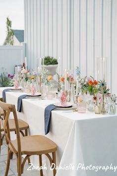 a long table is set with flowers and candles