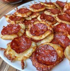 pepperoni and onion rings on a white plate