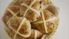 a basket filled with rolls covered in cheese and raisins