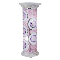 a pink and white candle holder with circular designs on the front, sitting against a white background