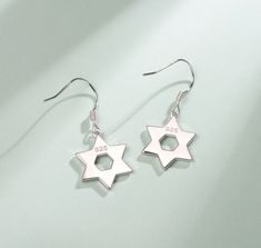 The "Opal Star of Heritage" drop earrings combine the classic Star of David symbol with the stunning beauty of opal, representing the connection between the divine and the earthly. It serves as a protective emblem and a source of spiritual guidance. Each piece in this set stylishly showcases this important symbol, creating a meaningful connection to tradition, faith, and personal identity. With its eye-catching design, this set is a beautiful way to celebrate and share your heritage. Symbolic Star Shaped Earrings For Gift, Silver Earrings Online, Opal Drop Earrings, Hypoallergenic Jewelry, Tool Gifts, Star Of David, Online Earrings, Pretty Gift, Colorful Bracelets