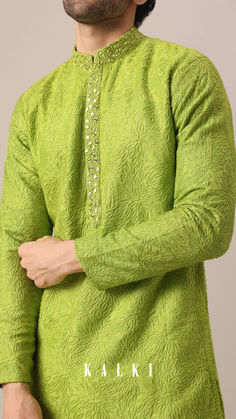 Accentuated with highlighted collar and front patti don this light green two-piece set to make a statement at the next festive gathering.
The self embroidery and Mandarin collar add to its depth.
Fabricated on comfortable cotton this ensemble comes with dola silk pants.
Dry-clean only if required. Mens Dresses, Self Embroidery, Green Two Piece, Silk Pant, Cotton Kurta, Silk Pants, Men's Wear, Pant Set, Green Cotton