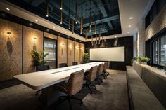 an empty conference room with chairs and a projection screen