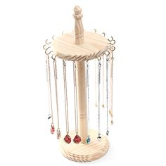 a wooden jewelry holder with chains hanging from it's sides and two necklaces attached to the top