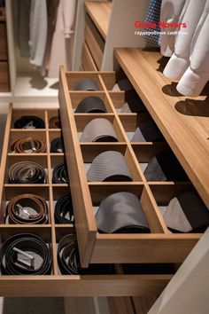 an open drawer in a closet filled with ties