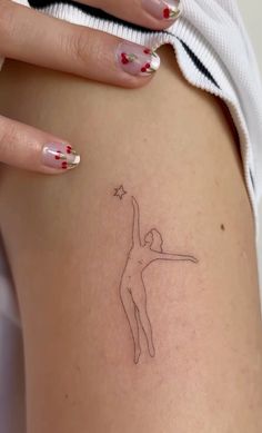 a woman's leg with a small tattoo on the back of her body, holding a star