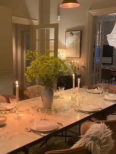 a dining room table with candles on it