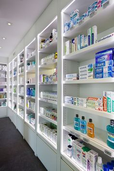 a pharmacy room filled with lots of bottles and medicine containers on shelves next to each other