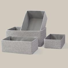 three grey baskets sitting next to each other