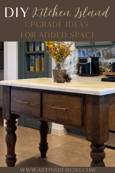 a kitchen island with marble top and wooden legs in front of a countertop that has flowers on it