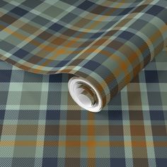 a blue and brown plaid wallpaper with a white circle at the center on it