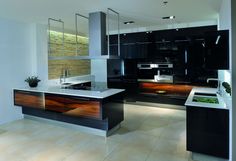 a modern kitchen with black cabinets and white counter tops