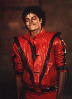 a man in a red leather jacket with his eyes closed