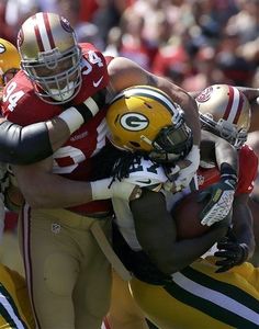 a group of football players are hugging each other