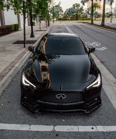 a black sports car parked on the side of the road