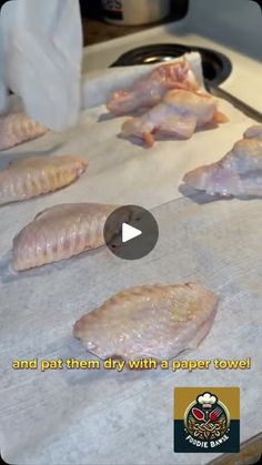 raw fish being prepared and put on a paper towel in the process of cooking them