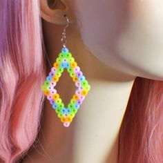 a close up of a mannequin head wearing earrings