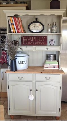 a kitchen with white cabinets and bookshelves