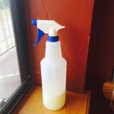 a spray bottle sitting on top of a window sill