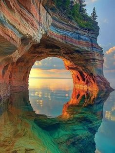 an image of the inside of a rock formation with water and trees around it in the foreground