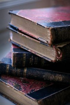 three old books stacked on top of each other