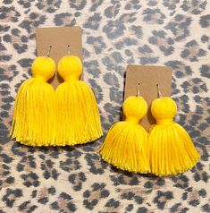 These stylish Tassel Earrings are the perfect accessory for any outfit. Made from high quality materials, these earrings are both durable and lightweight. With their elegant design and colorful tassels, they add a fun and playful touch to your look. Whether you're dressing up for a special occasion or just adding some flair to your everyday outfit, these earrings are sure to impress. Key Features: - High quality materials - Lightweight design - Elegant and colorful tassels - Perfect accessory fo Yellow Fringe Tassel Earrings, Yellow Fringe Earrings For Summer, Elegant Yellow Fringe Earrings, Trendy Tassel Dangle Earrings With Fringe, Trendy Fringe Tassel Dangle Earrings, Yellow Fringe Tassel Drop Earrings, Adjustable Beaded Tassel Earrings, Elegant Yellow Tassel Earrings, Yellow Tassel Earrings As Gift