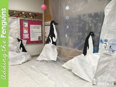 penguins are wrapped in plastic and standing on the ground