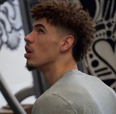 a close up of a person with curly hair and a goatee on his head