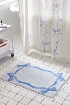 a bathroom with a bathtub, rug and shower curtain