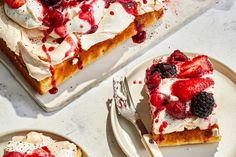 there is a piece of cake with berries on top and whipped cream on the bottom