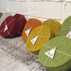 several different colored round boxes with tags on them