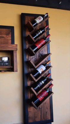 a wooden wine rack mounted to the side of a wall