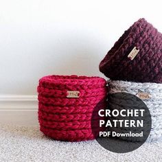 three crochet baskets sitting next to each other on top of a white carpet