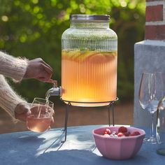 a person is pouring some liquid into a jar